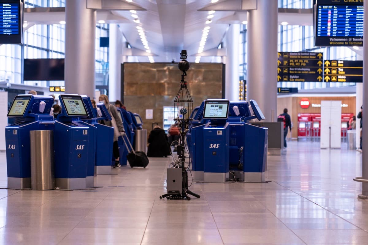 The HOA-SSR recording rig, a spherical microphone array under a 360° camera, recording in an airport check-in hall